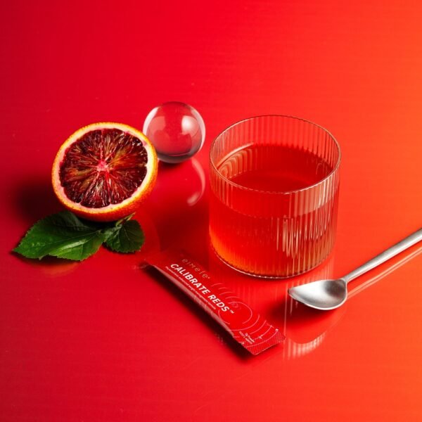 Eimele Calibrate Reds Red Orange Drink Eimele Calibrate Reds with red orange, sachet and prepared drink